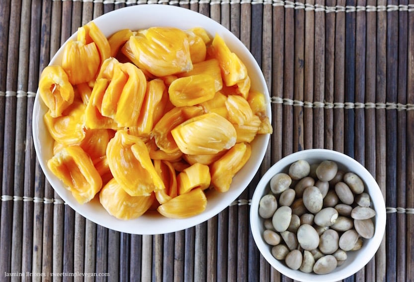 Image of jackfruit pods in a bowl with a smaller bowl of seeds. 