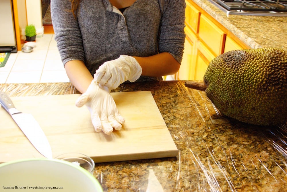 image of putting on gloves getting ready to cut jackfruit. 