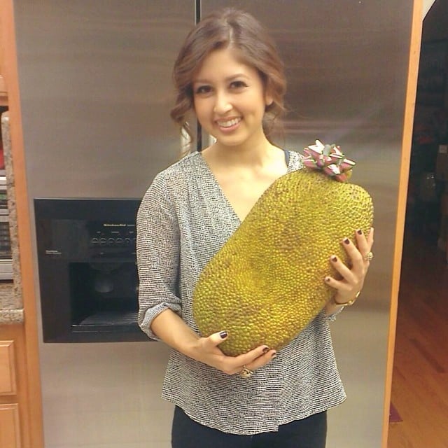 Jasmine holding a jackfruit. 