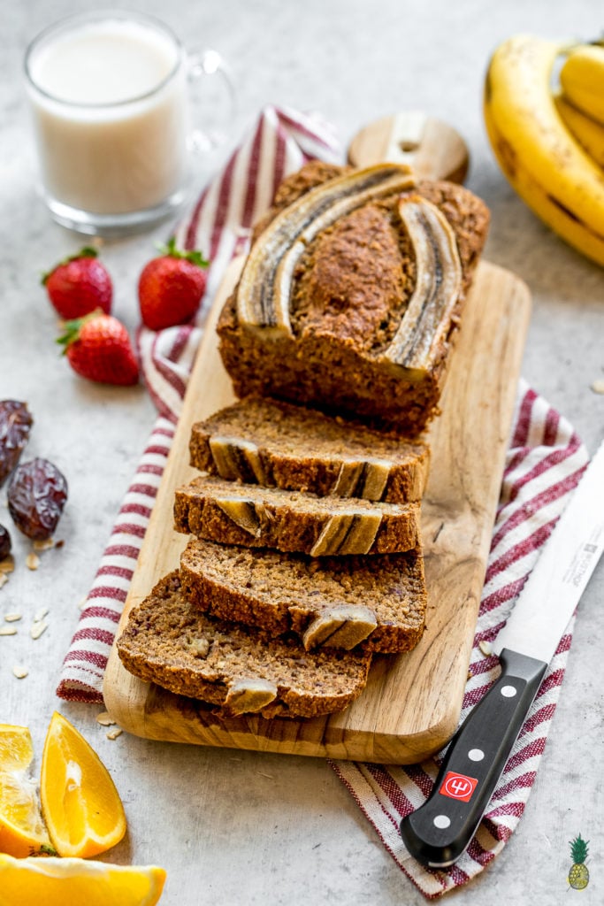 3/4 angle photo of sliced banana bread styled with fruits 