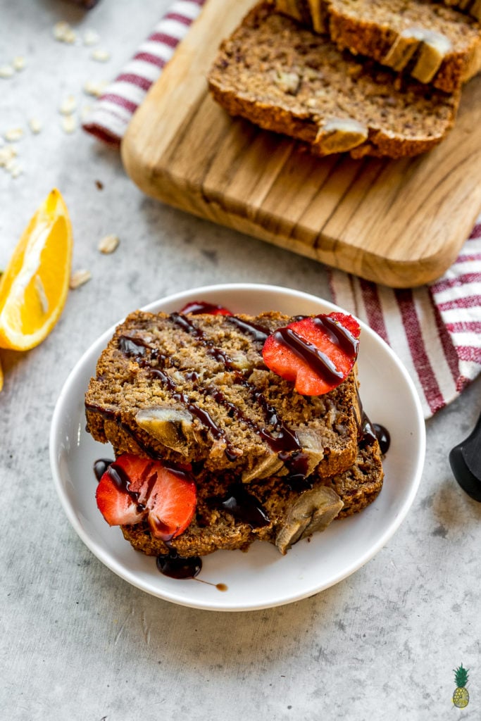 image of banana bread on plate with chocolate sauce and strawberries 