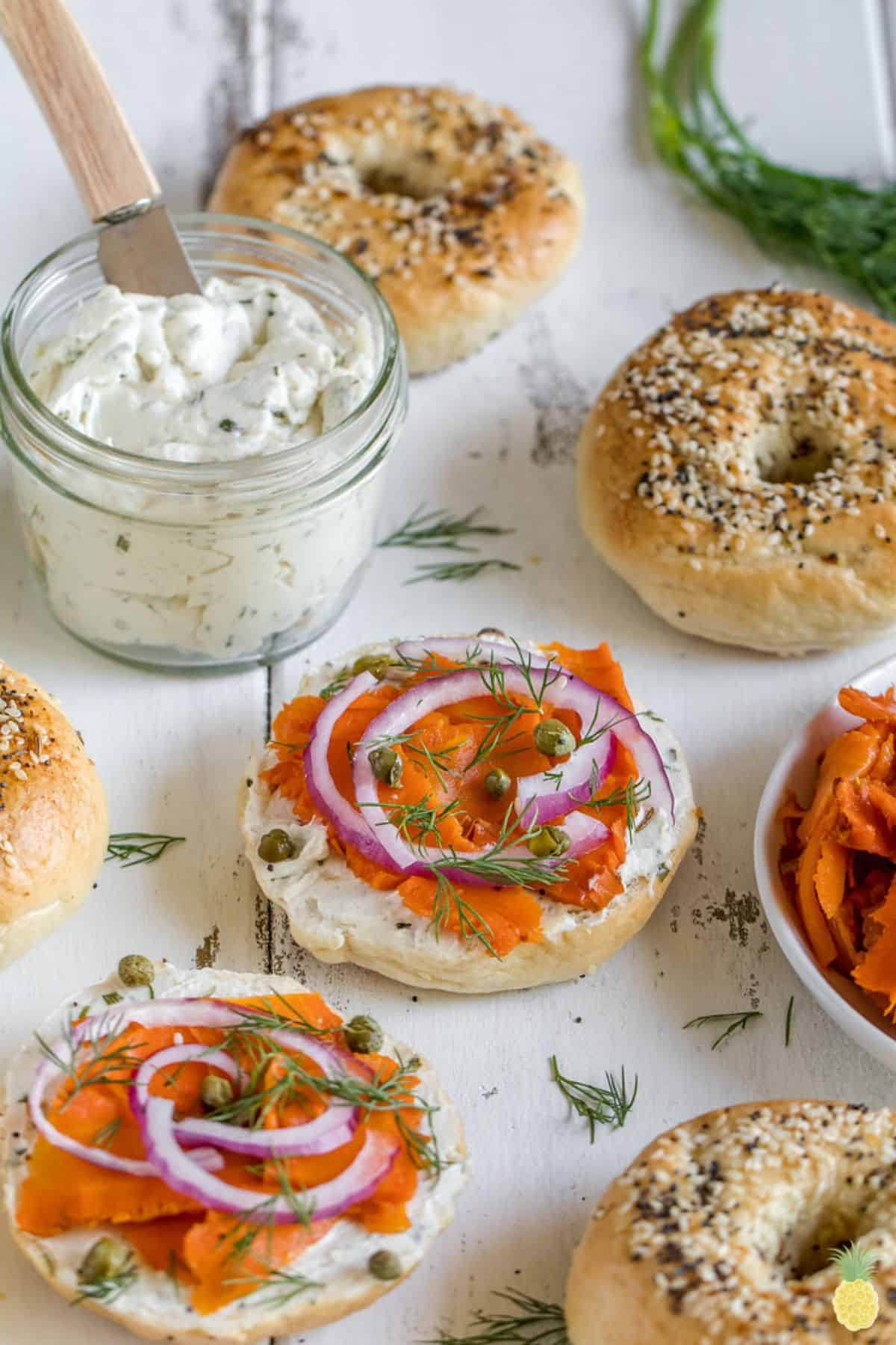 Carrot lox on bagel with red onion, dill, and vegan cream cheese.