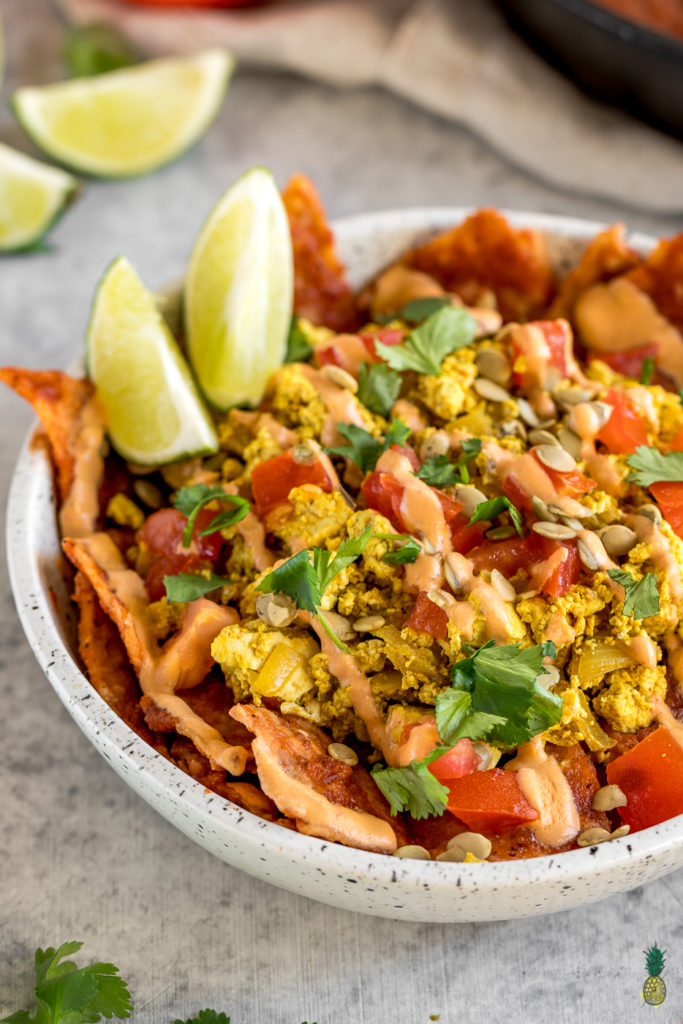 These vegan chilaquiles are spot on! They really do live up to being the BEST recipe, definitely a must try! Loaded up with a homemade red sauce, tofu scramble and chipotle crema, this is definitely a breakfast to impress a crowd. #vegan #chilaquiles #veganchilaquiles #veganbreakfast #mexican #veganmexican #veganized #party #brunch #musttry #tortillas #authentic