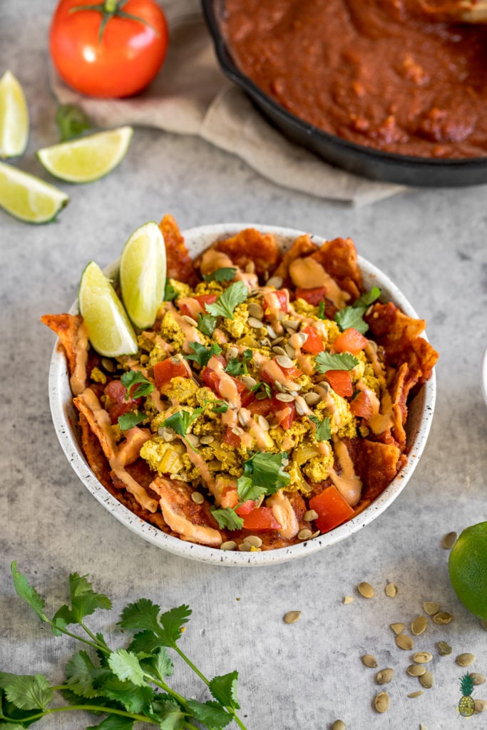 These vegan chilaquiles are spot on! They really do live up to being the BEST recipe, definitely a must try! Loaded up with a homemade red sauce, tofu scramble and chipotle crema, this is definitely a breakfast to impress a crowd. #vegan #chilaquiles #veganchilaquiles #veganbreakfast #mexican #veganmexican #veganized #party #brunch #musttry #tortillas #authentic