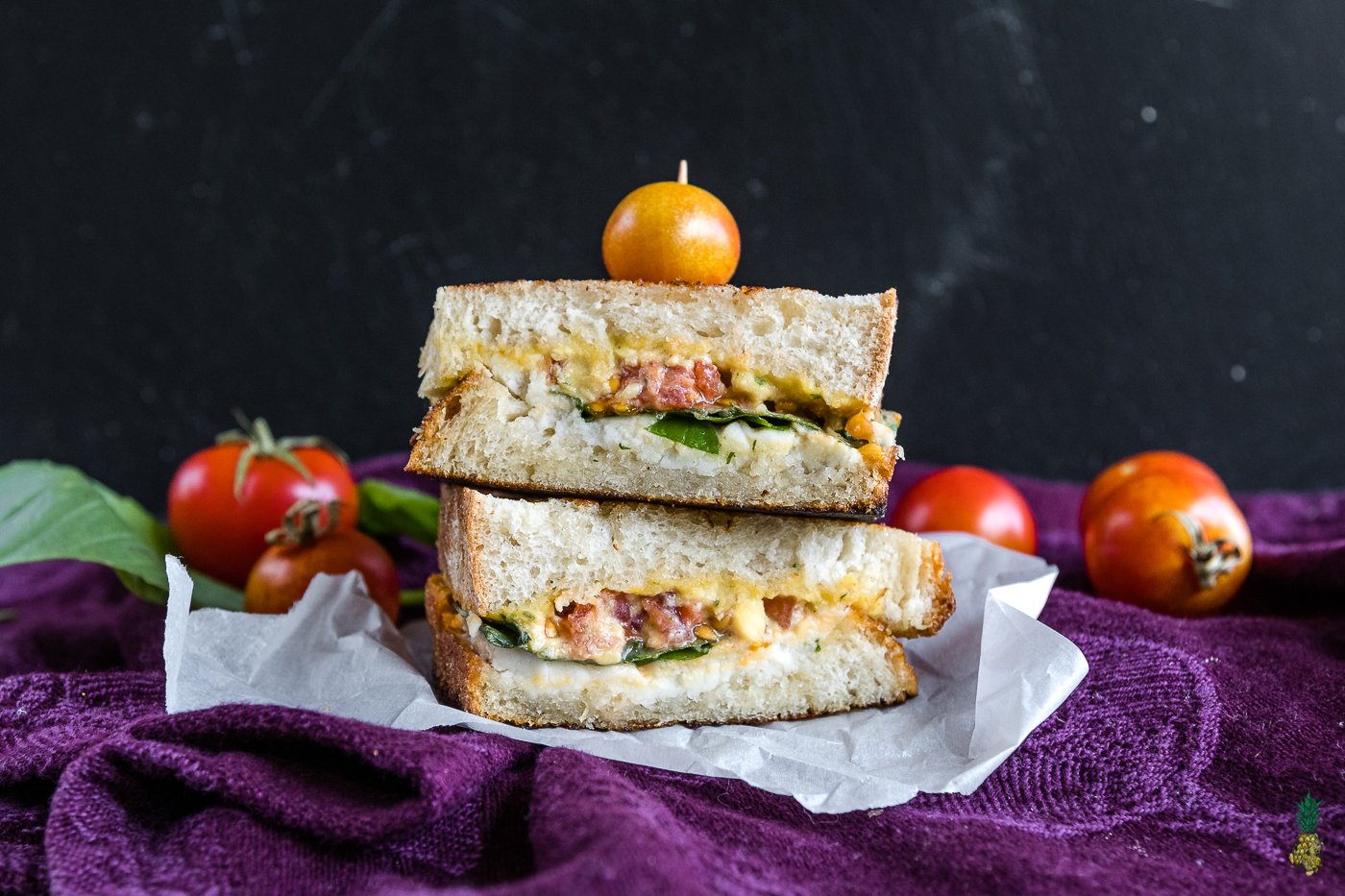 Grilled cheese brought to a whole new level! This vegan caprese grilled cheese will satisfy anyone, vegan or not! It is easy to make, decadent and so dang good! #vegan #caprese #grilledcheese #sandwich #entree #lunch #dinner #vegansandwich #bestvegan #veganized #italian