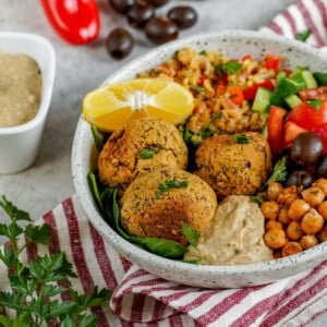 The best buddha bowl rendition yet! This Vegan Mediterranean Buddha Bowl is hearty, nutritionally dense, jam packed with flavor and easy to make! #Vegan #Mediterranean #Buddha #Bowl #entree #veganbowl #easy #lunch #work #onthego #budget #musttry #fresh #falafel #chickpeas #hummus #homemade