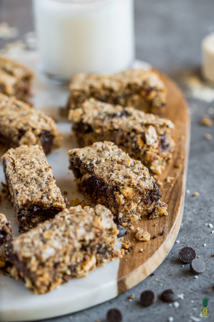 The perfect on the go snack or breakfast that is perfect for meal prep! With these vegan chocolate chip protein cookie bars, you won't have to buy protein bars at the store ever again! These are sweet, chewy, chocolatey and packed with healthy plant-based protein. #vegan #protein #plantbased #vanilla #proteinpowder #snack #mealprep #breakfast #oilfree #glutenfree #musttry #homemadeproteinbar #proteinbars #gym #workout #postworkout #healthysnack