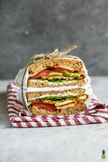 The viral TTLA sandwich from Whole Foods just made its way into your kitchen. Learn how to make this delicious vegan recipe from scratch, loaded with tempeh bacon, tomatoes, lettuce, avocado and a homemade garlic aioli. Get ready to dig into your new favorite sandwich! #vegan #sandwich #ttla #homemade #wholefoods #easyrecipe #healthyrecipe #veganlunch #veganentree #vegansandwich #restaurantstyle