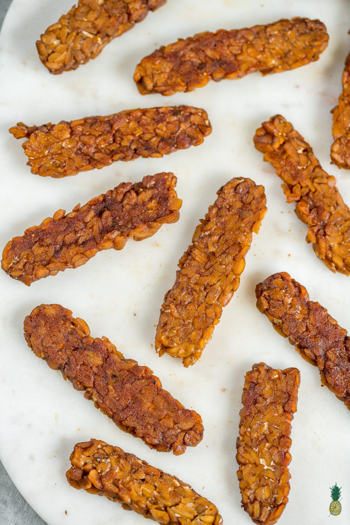 Making tempeh bacon at home is so easy and requires just 8 ingredients! Just whisk everything together, marinate it for a bit and cook it up to perfection. This is the perfect protein packed addition to your next breakfast! #tempeh #bacon #vegan #protein #easy #8ingredient #musttry #homemade #veganbreakfast #veganside #veganbacon #tempehbacon #howto #foolproof #easy