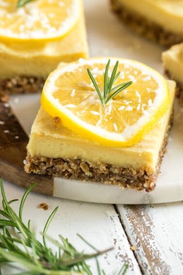With the perfect balance of tart and sweet, these creamy lemon bars are a must try dessert. They are of course 100% vegan, and also 100% delicious. Plus, they are naturally-sweetened and gluten-free--say whaaaat! #vegan #dessert #lemon #rosemary #mindblowing #sweet #refinedsugarfree #naturallysweetened #medjooldates #coconutoil #unique #musttry #veganized #eggfree #dairyfree #snack #lemonbars