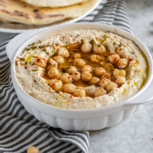 Learn how to make the BEST hummus at home. It is SO easy to make and is better than anything you can find in stores. With just a few simple ingredients and a little bit of patience, you'll be well on your way to a party in your mouth! #hummus #homemade #snack #side #kids #lunch #onthego #healthy #oilfree #musttry #vegan #mediterranean #fresh