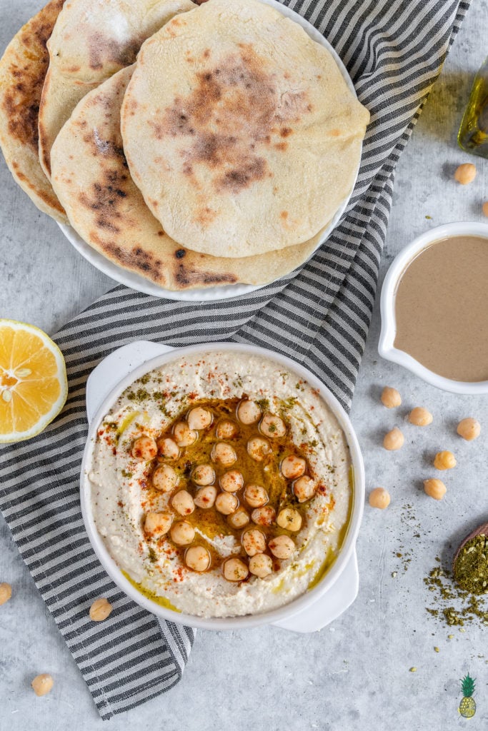 Learn how to make the BEST hummus at home. It is SO easy to make and is better than anything you can find in stores. With just a few simple ingredients and a little bit of patience, you'll be well on your way to a party in your mouth! #hummus #homemade #snack #side #kids #lunch #onthego #healthy #oilfree #musttry #vegan #mediterranean #fresh