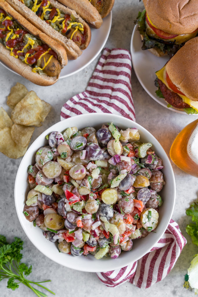 Memorial Day is coming up and we got you covered with the perfect party recipe! Your summer cookout this year will be taken to the next level with this bomb AF potato salad! Fresh veggies, herbs, and an amazing creamy vegan dressing; this potato salad is packed with flavor and appeals to just about anybody! #bbq #vegan #memorialday #easy #potatosalad #fresh #cookout #summertime #veganbbq #musttry #wholefoods #sweetsimplevegan