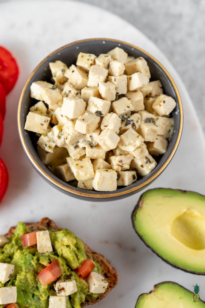 An easy and delicious vegan feta cheese that is made out of tofu and will make all of your dreams come true. This cheese swaps perfectly with its nonvegan counterpart and the possibilities for serving it are endless! #vegan #vegancheese #feta #easy #foolproof #salad #appetizer #side #avocadotoast #veganpasta #veganized #musttry