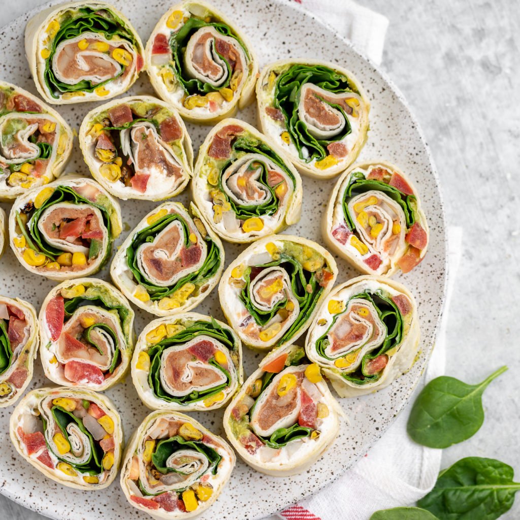 These easy 7-ingredient Mexican-Inspired pinwheels are a must try! They make for the perfect appetizer or lunch and are even great to take on the go! We love bringing these along with our summer picnics and packing them for school lunches. #vegan #appetizer #lunch #summer #picnic #onthego #mexican #inspired #pinwheel #bentobox #lunchbox #veganized #7ingredients