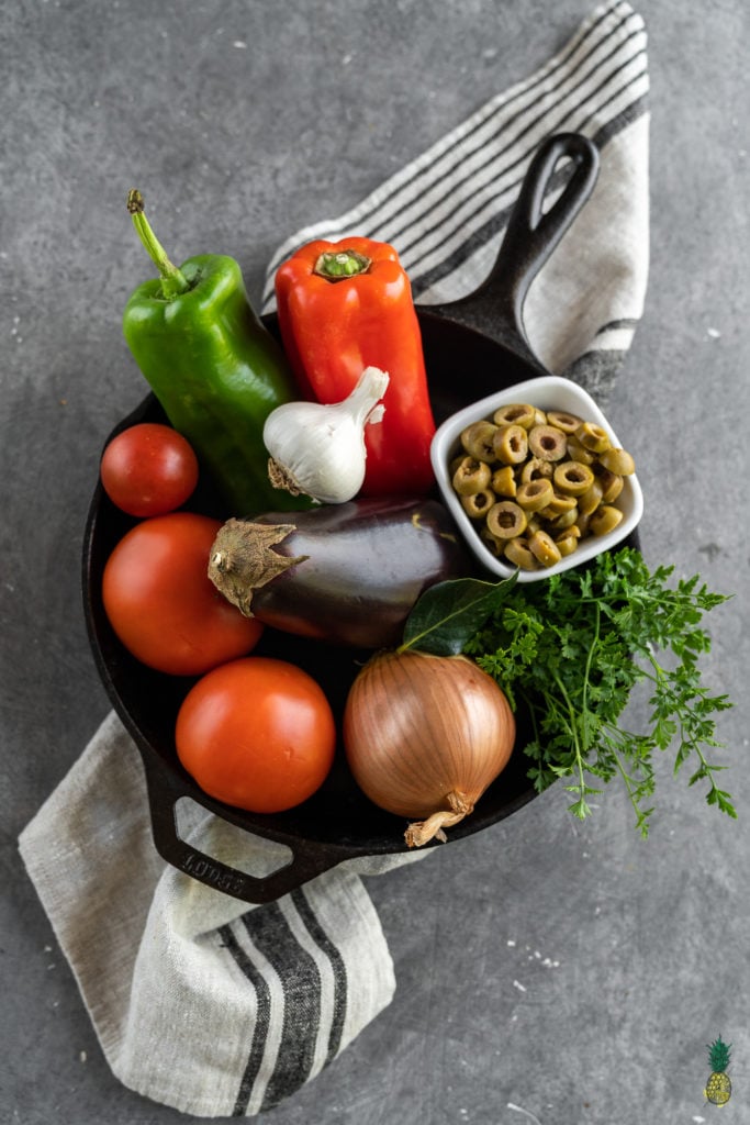 If you haven't had shakshuka before, you are in for a treat! This dish is loaded with a plethora of vegetables in a thick tomato sauce, topped with a flavor-packed tofu scramble, and ready in less than 30 minutes! #shakshuka #breakfast #lunch #dinner #tunisia #middleeastern #northafrica #israel #shakshouka #veganized #egg #tofuscramble #healthy #lowfat #30minute #meal #easy #sweetsimplevegan #entree #onthego #togo