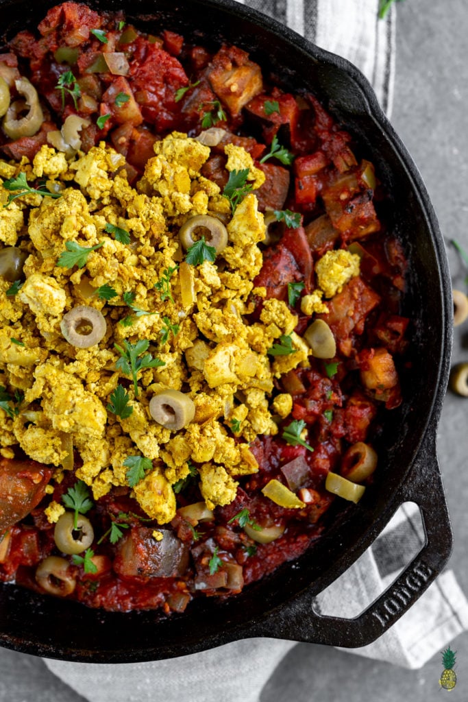 If you haven't had shakshuka before, you are in for a treat! This dish is loaded with a plethora of vegetables in a thick tomato sauce, topped with a flavor-packed tofu scramble, and ready in less than 30 minutes! #shakshuka #breakfast #lunch #dinner #tunisia #middleeastern #northafrica #israel #shakshouka #veganized #egg #tofuscramble #healthy #lowfat #30minute #meal #easy #sweetsimplevegan #entree #onthego #togo