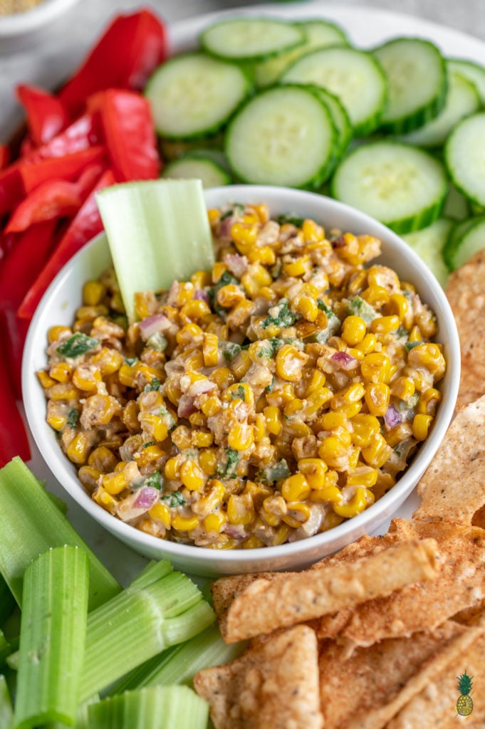 An easy and flavor-packed Mexican street corn inspired dip that is ready in just 15-minutes. This recipe is loaded with corn, jalapeños, red onions and more, and will definitely be a hit at your next gathering! #mexican #streetcorn #dip #vegandip #vegan #elote #musttry #veganparty #holiday #easy #15minutes #nofuss #snack #side #appetizer