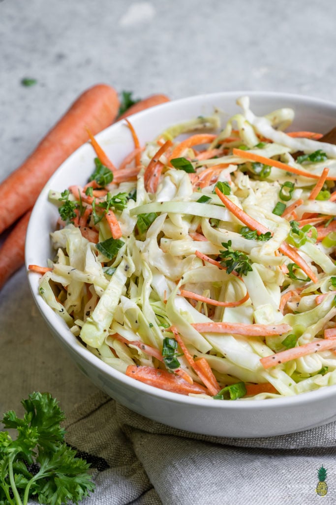 A quick & easy vegan coleslaw recipe just like what we remember digging into growing up. It's creamy and crunchy with the perfect amount of bite, plus it only takes 10 minutes to make! #thebest #vegan #coleslaw #summer #recipe #side #appetizer #pulledjackfruit #barbecue #sandwiches #salad #veganparty #lastminuterecipe #quickrecipe #easyvegan #sweetsimplevegan