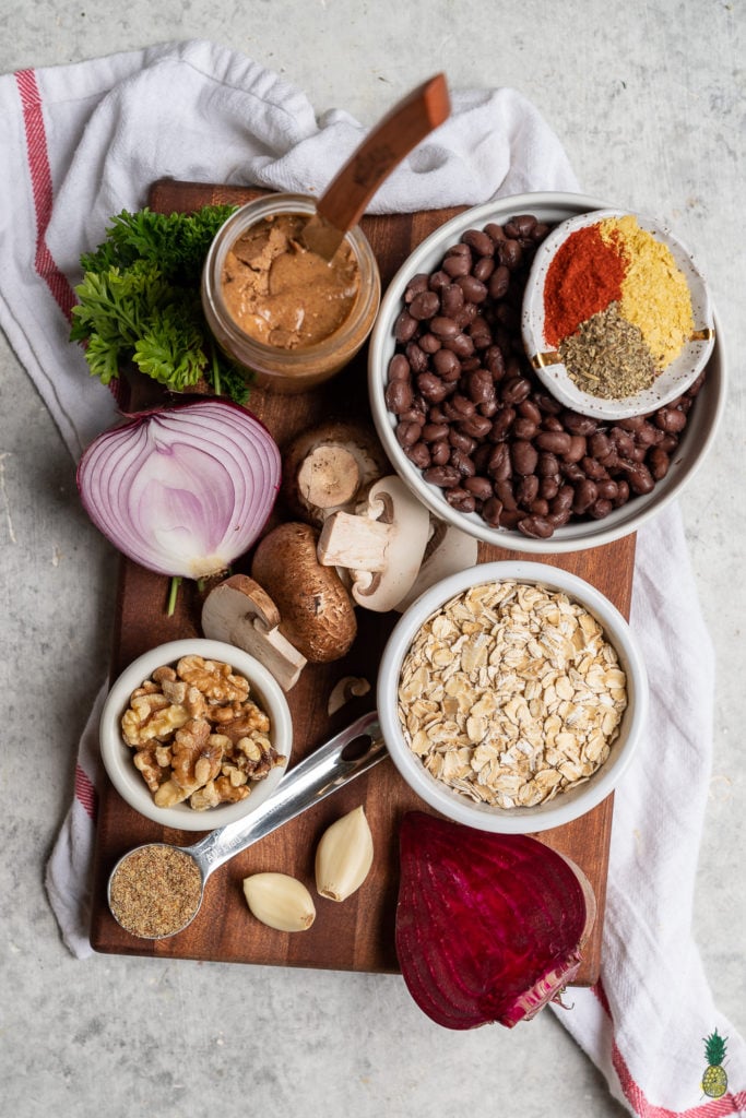 A flavor-packed, nutrient dense and protein-rich veggie burger that is the perfect dish to serve at a summer party. It is easy to make and can be prepared ahead of time and frozen for an easy meal! #summer #grilling #veganburger #beet #mushroom #veganprotein #entree #lunch #dinner #makeahead #frozen #mealprep #blackbeanburger #sweetsimplevegan