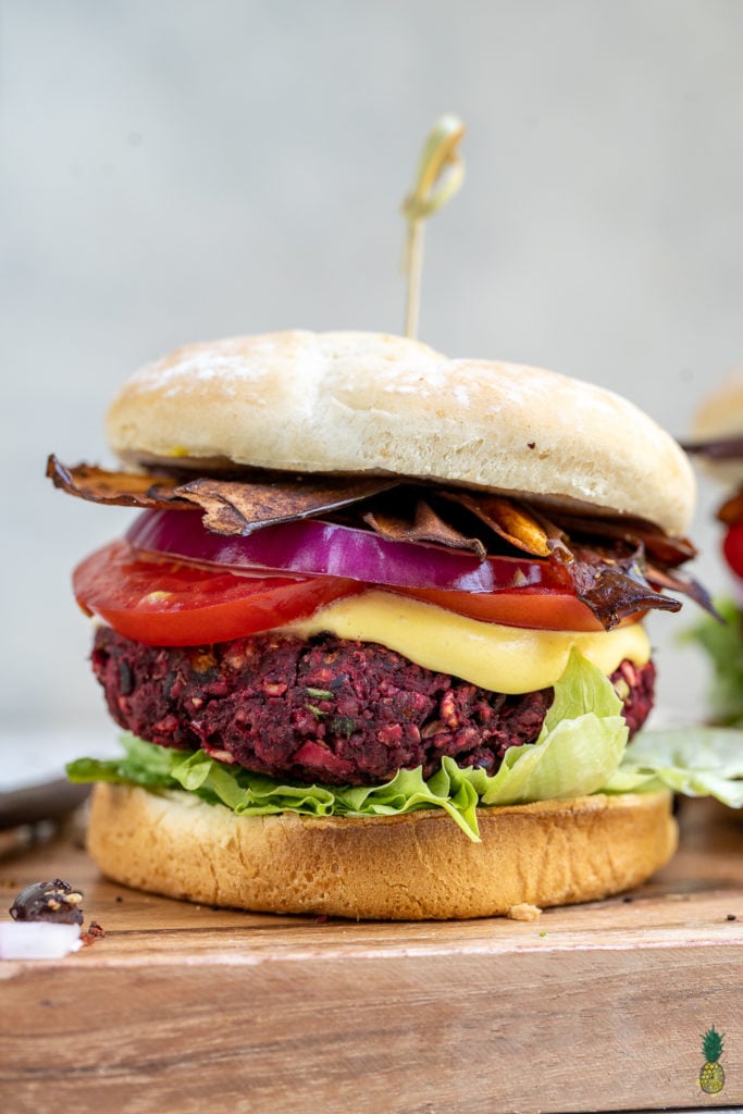 A flavor-packed, nutrient dense and protein-rich veggie burger that is the perfect dish to serve at a summer party. It is easy to make and can be prepared ahead of time and frozen for an easy meal! #summer #grilling #veganburger #beet #mushroom #veganprotein #entree #lunch #dinner #makeahead #frozen #mealprep #blackbeanburger #sweetsimplevegan