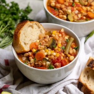 This is the perfect way to make use of the beautiful produce that is in season this summer. Zucchini, green beans, tomatoes, corn and so much more, this recipe is bursting with flavor and makes for the perfect appetizer or entree. Plus, this summer stew is ready in 30 minutes or less! #summer #stew #vegan #protein #whitebeans #entree #lunch #dinner #side #sppetizer #summerrecipe #veganyackattack #onthego #musttry #30minute #onepot