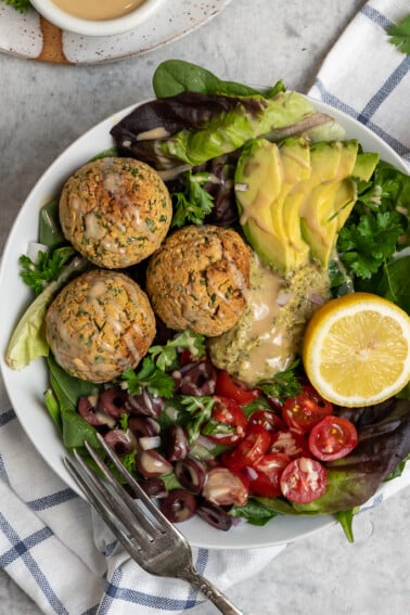 A healthier version of falafel that is baked instead of fried, gluten-free,  is jam-packed with flavor and nutritionally dense! Plus it is vegan, gluten-free and oil-free! #vegan #falafel #oilfree #glutenfree #lunch #dinner #entree #baked #foolproof #chickpeas #easyrecipes #tastyrecipes #sweetsimplevegan #party #snack