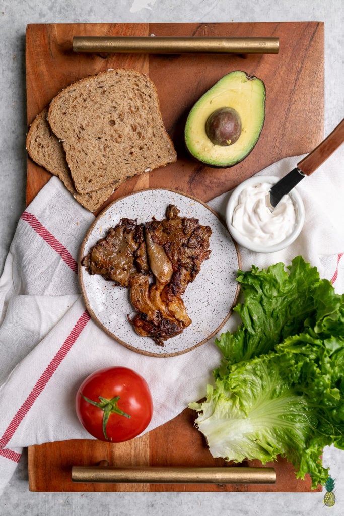 Behold your new favorite sandwich—a quick and easy oyster mushroom sandwich made in just 15 minutes that is packed with flavor and easy to take on the go! #MLTA #BLTA #Vegansandwich #easymeal #lazymeal #veganized #impressivelunch #onthego #musttry #lastminute #partymeal #kidslunch #summer #sweetsimplevegan