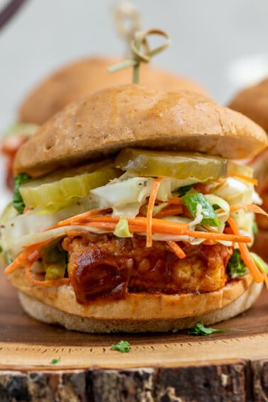 A delicious and simple tofu sandwich smothered in a tangy date-sweetened barbecue sauce and topped with a crunchy homemade slaw! #vegan #barbecue #coleslaw #musttry #tofusandwich #veganprotein #vegansummerrecipe #bestvegansandwich #entree #lunch #dinner #party #potluck