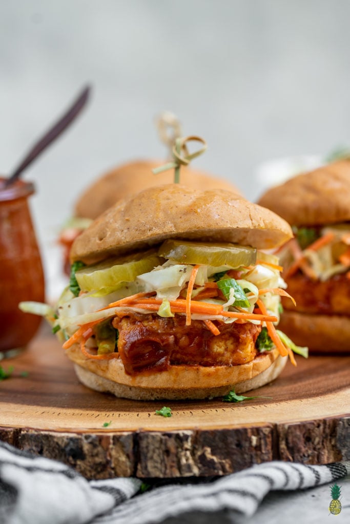 A delicious and simple tofu sandwich smothered in a tangy date-sweetened barbecue sauce and topped with a crunchy homemade slaw! #vegan #barbecue #coleslaw #musttry #tofusandwich #veganprotein #vegansummerrecipe #bestvegansandwich #entree #lunch #dinner #party #potluck