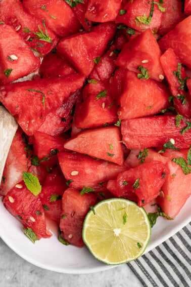 Taking fruit to a party this summer? Bring it to a whole new level with this 5-ingredient watermelon mojito salad! It is light, refreshing and bursting with flavor plus it is ready in just 10 minutes! #watermelon #watermelonmojito #salad #refreshing #summer #party #lastminute #snack #appetizer #oilfree #glutenfree #rawvegan #uniquesummer #sweetsimplevegan