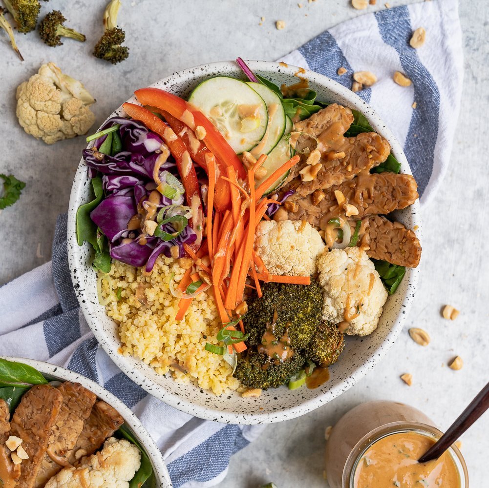 These Thai peanut grain bowls are easy to make and are perfect for an on the go lunch or dinner! Peanut Sauce, roasted veggies, tempeh, and millet, it will keep you full and fueled for the day. Plus, they are vegan and can easily be made gluten-free. #vegan #glutenfree #backtoschool #grainbowl #millet #lunch #entree #kids #protein #tempeh #easy #mealprep #easyvegan #healthy