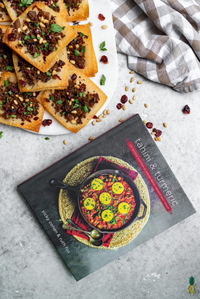 This recipe makes for the perfect appetizer or snack! A delicious tofu "meat" seasoned with fresh onions, sundried tomatoes, parsley, pomegranate molasses, cinnamon, and allspice, and served atop crispy spring roll wrappers. It is the perfect balance of sweet and savory, and the ingredient combination makes for such a fresh and flavorful dish! #tahiniandturmeric #tahini #turmeric #mayihavethatrecipe #cookbook #giveaway #lebanesepizza #armenianpizza #middleeastern #veganized #sweetsimplevegan #snack #appetizer #side