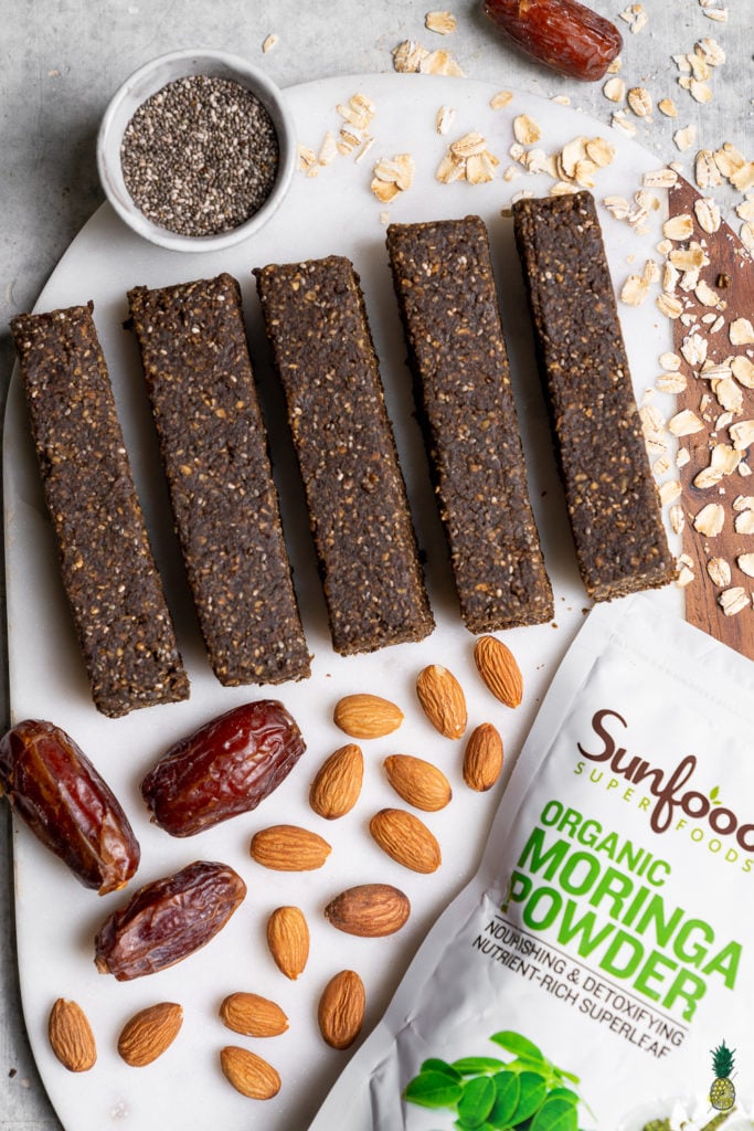 You'd never guess that these Pumpkin Spiced Moringa Energy Bars are healthy and gluten-free! They are loaded with healthy and easy to find ingredients, can be made in less than half an hour at home and will give you the boost of energy you need for a long day at school or work. #vegan #pumpkinspiced #energybars #backtoschool #schoolsnack #collegesnack #dormroom #student #kidrecipe #work #30minute #homemade #sweetsimplevegan