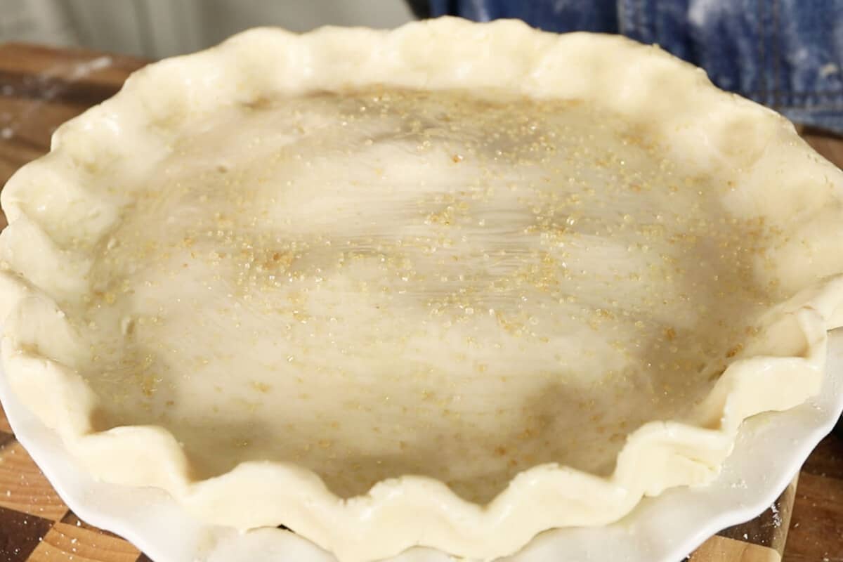 turbinado sugar on top of unbaked apple pie