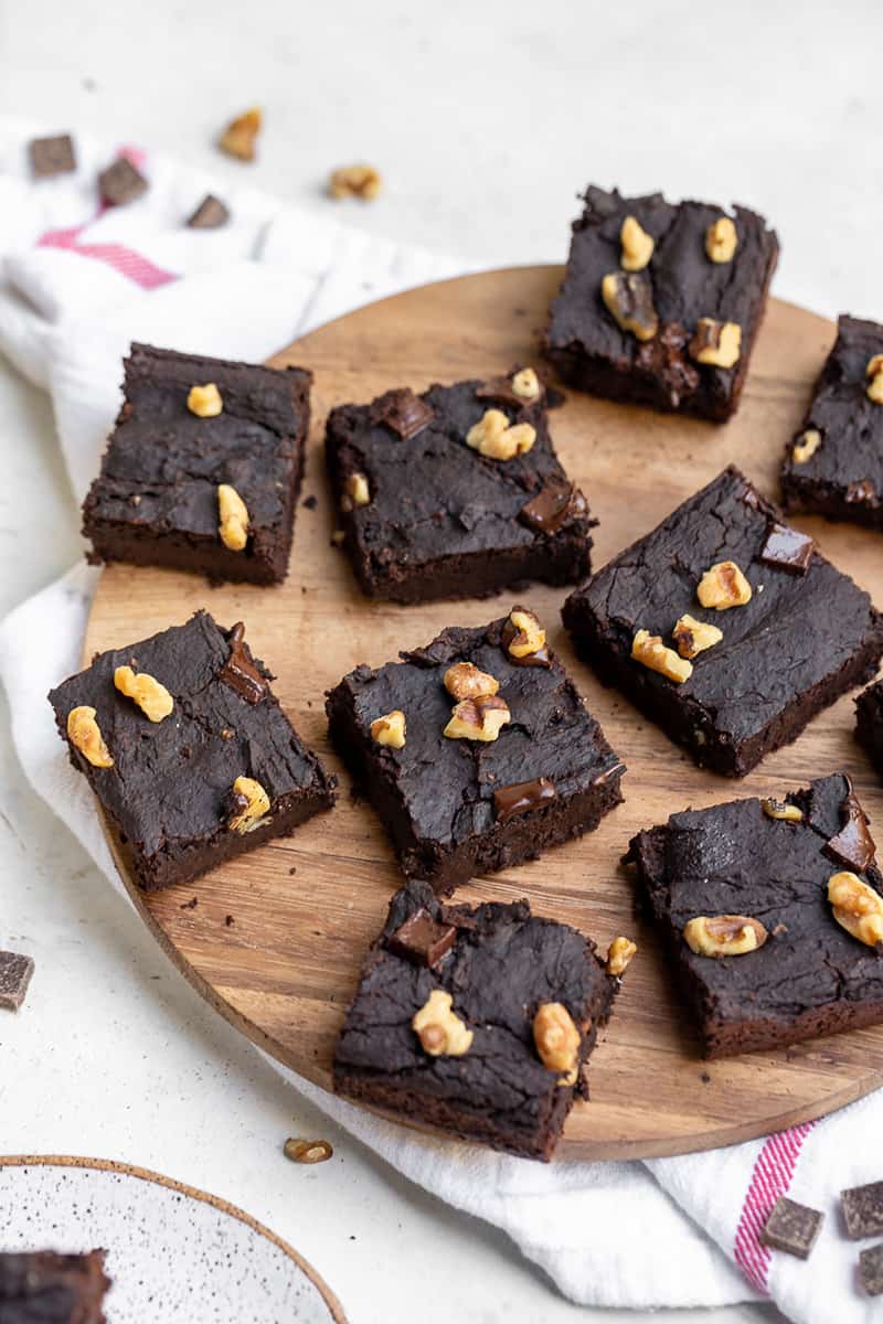 wooden board with slices of vegan black bean brownies on top