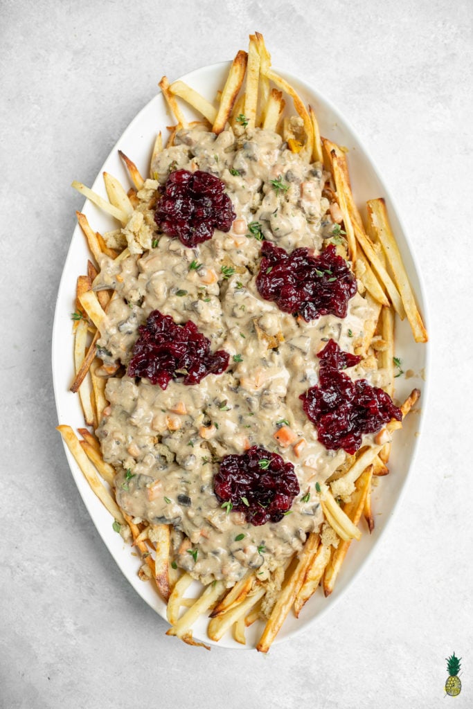 A great way to use up Thanksgiving leftovers that is simple and easy to make. This poutine is delicious and a great way to change things up if you are bored of plain ol' leftovers. Plus, it's vegan! #vegan #thanksgiving #leftovers #musttry #kidfriendly #easy #stuffing #gravy #veganroast #homemadefried #cranberrysauce #veganthanksgiving #poutine