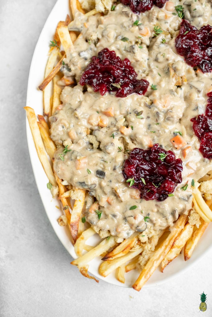A great way to use up Thanksgiving leftovers that is simple and easy to make. This poutine is delicious and a great way to change things up if you are bored of plain ol' leftovers. Plus, it's vegan! #vegan #thanksgiving #leftovers #musttry #kidfriendly #easy #stuffing #gravy #veganroast #homemadefried #cranberrysauce #veganthanksgiving #poutine
