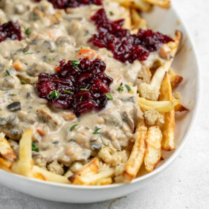 A great way to use up Thanksgiving leftovers that is simple and easy to make. This poutine is delicious and a great way to change things up if you are bored of plain ol' leftovers. Plus, it's vegan! #vegan #thanksgiving #leftovers #musttry #kidfriendly #easy #stuffing #gravy #veganroast #homemadefried #cranberrysauce #veganthanksgiving #poutine