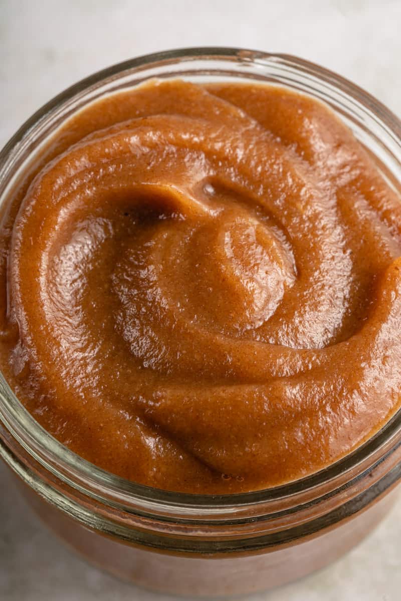 close up of date caramel in a glass jar