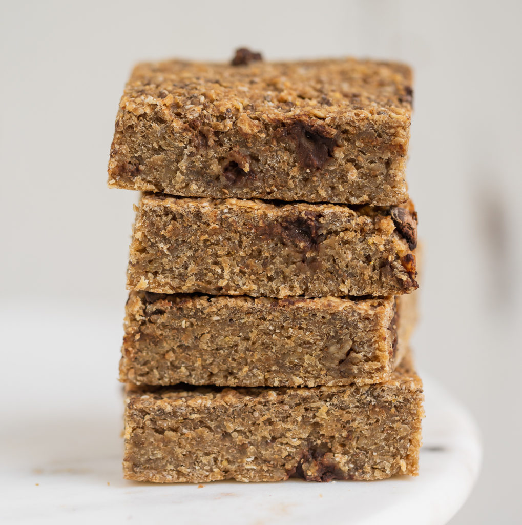 stacked up healthy Oatmeal breakfast bars on white marble.