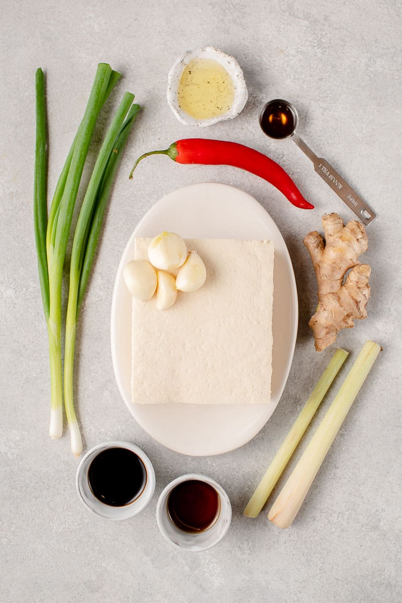ingredients for lemongrass tofu on a white board