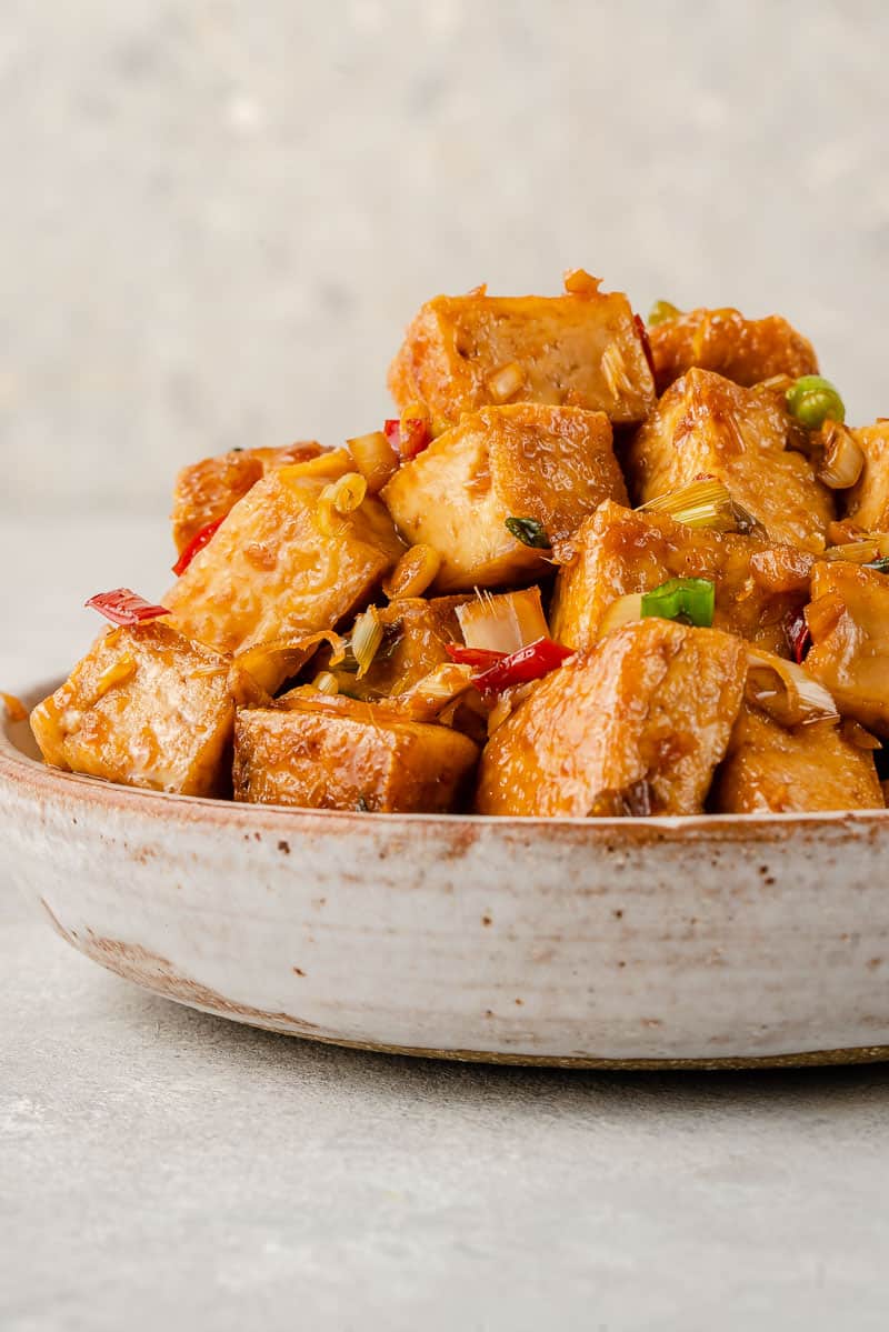 close up photo of lemongrass tofu stacked in a bowl