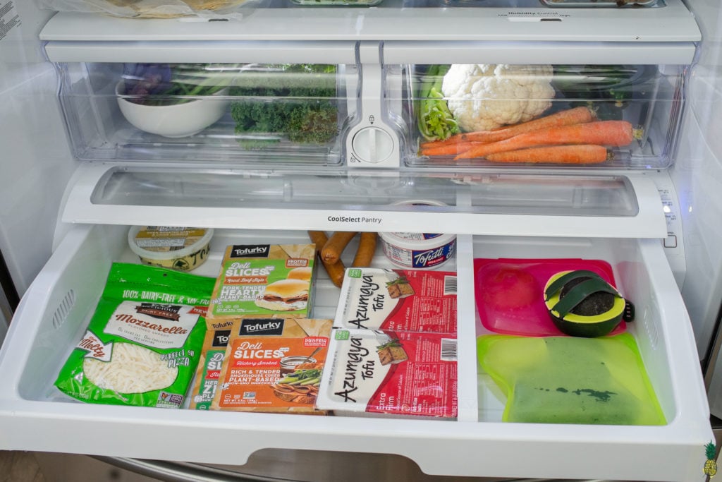 Vegan meats and cheeses in a fridge drawer