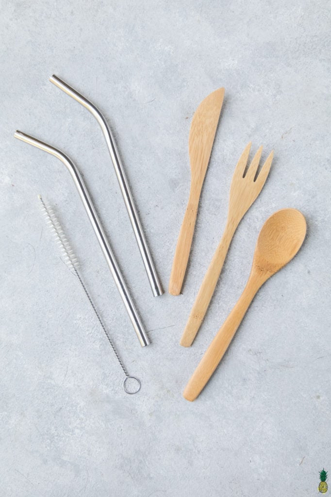 overhead photo of reusable straws and utensils