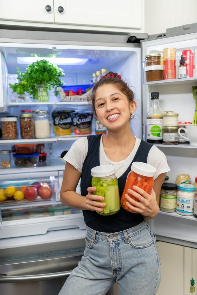 Standing in front of the open fridge with vegetables. Sweet Simple vegan fridge