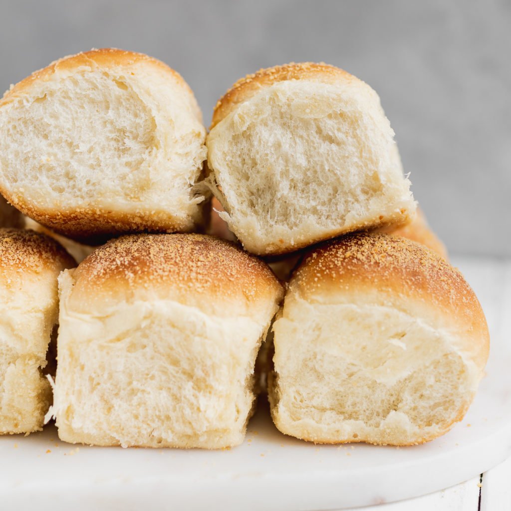 Vegan filipino pandesal bread rolls stacked by Sweet Simple Vegan Blog