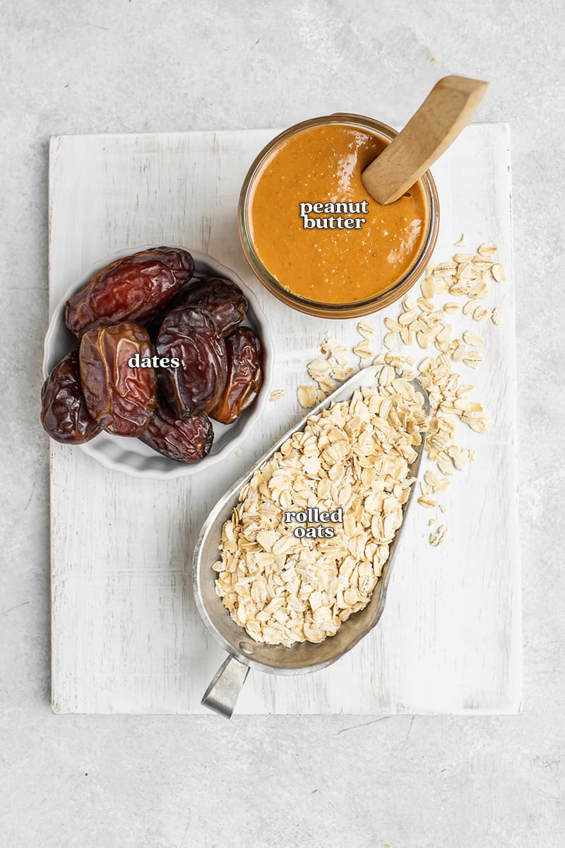 dates, rolled oats and peanut butter on white cutting board