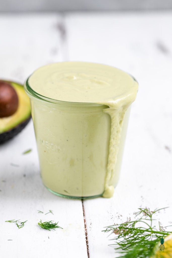 straight forward shot of cup filled with avocado tahini dressing