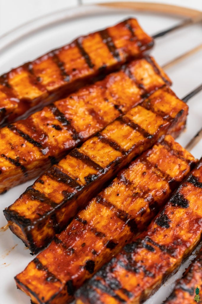 up close photo of grilled tofu skewers on plate